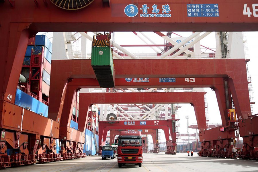 Trucks transport containers at a port in Qingdao, Shandong province on China 8 April 2018 - Reuters photo