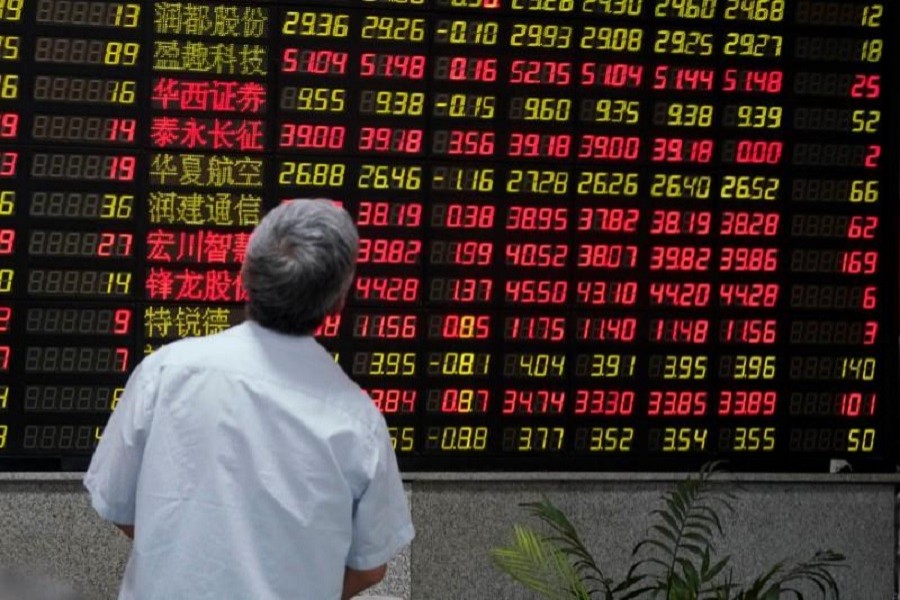 A man looks at an electronic board showing stock information at a brokerage house in Shanghai, China, July 6, 2018. Reuters