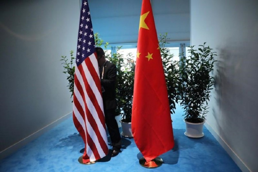 A Chinese official prepares the flags for the China-USA bilateral meeting at the G20 leaders summit in Hamburg, Germany, July 8, 2017. Reuters/File Photo