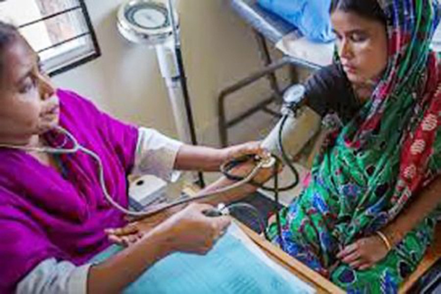 A health worker doing the health check-up of a patient as part of family planning services 	— BSS