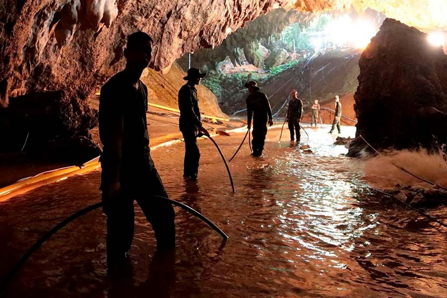 Thai cave rescuers free four boys, suspend operations