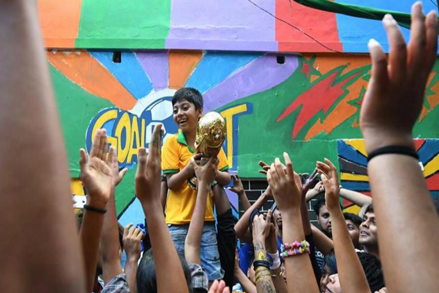 Bangladeshi fans celebrating with replica of the FIFA World Cup 	— FIFA World Cup official site