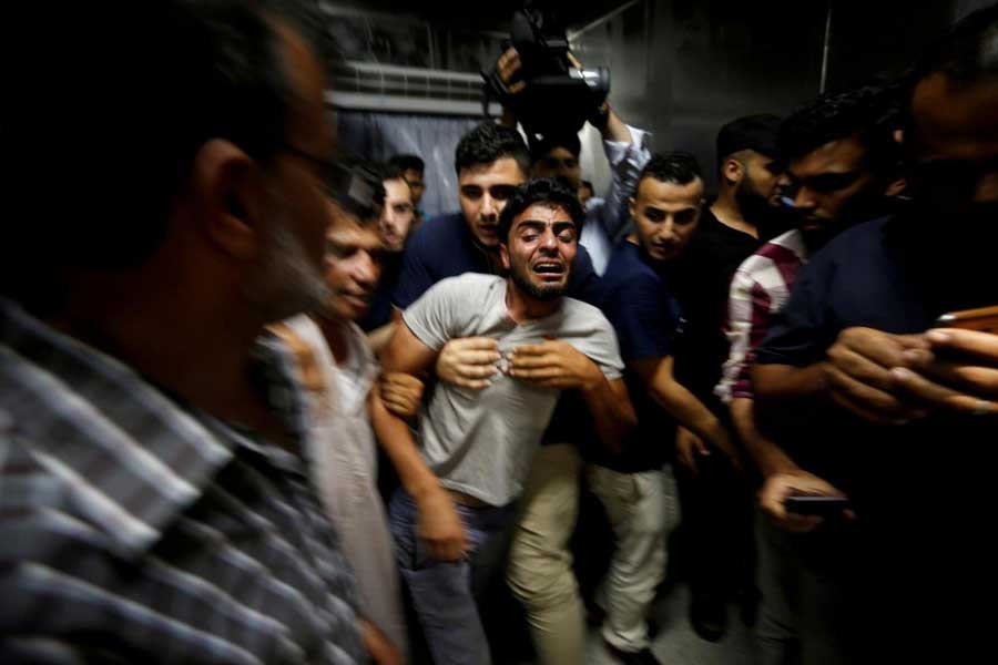 The brother of a Palestinian teenager who was killed in an Israeli air strike, reacts in Gaza City July 14, 2018. Reuters