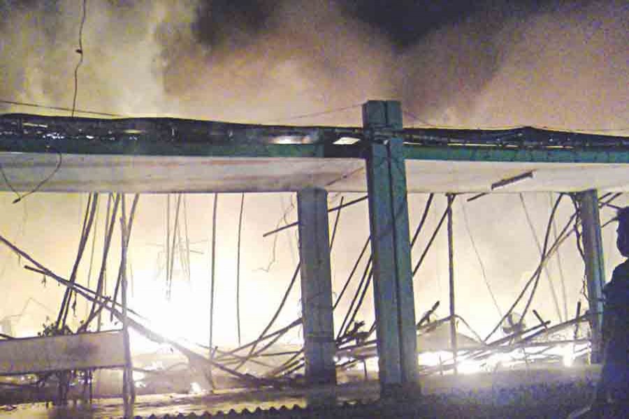 A fire burns the stage built for the 57th founding anniversary celebration of Bangladesh Agricultural University in Mymensingh Saturday night. Photo: Collected