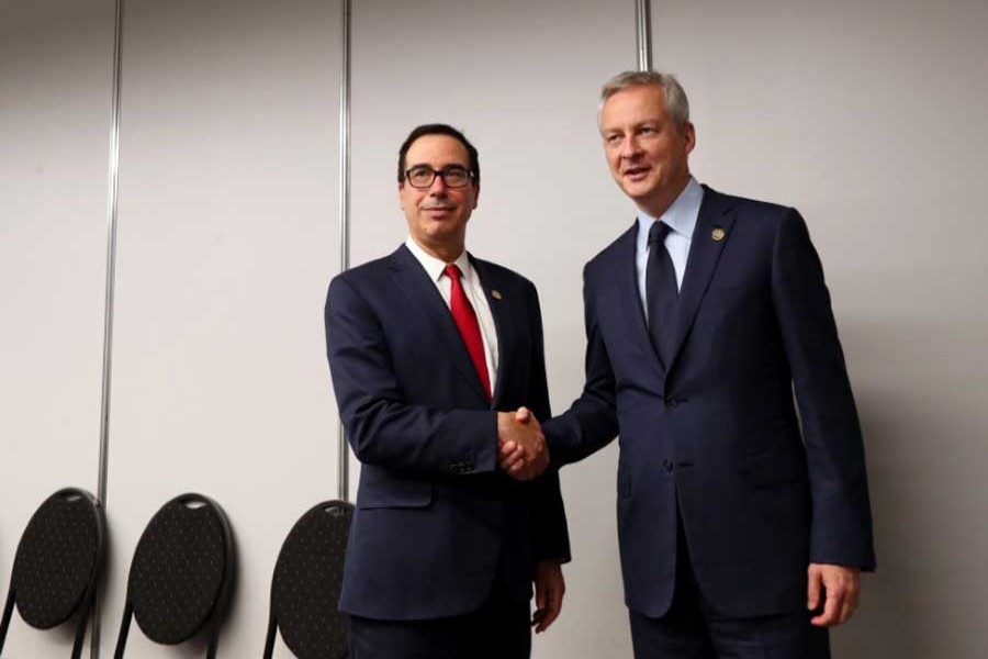 US Secretary of the Treasury Steven Mnuchin and France's Finance Minister Bruno Le Maire shake hands at the G20 Meeting of Finance Ministers in Buenos Aires, Argentina, July 21, 2018. Reuters