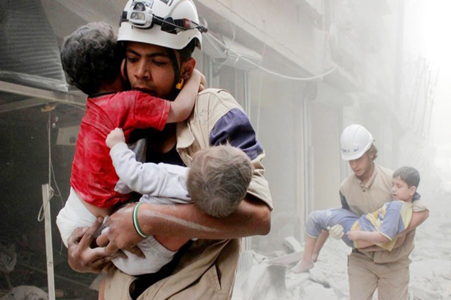 Members of the Civil Defence rescuing children after what activists said was an air strike by forces loyal to Syria's President Bashar al-Assad in Aleppo on Sunday	— Reuters