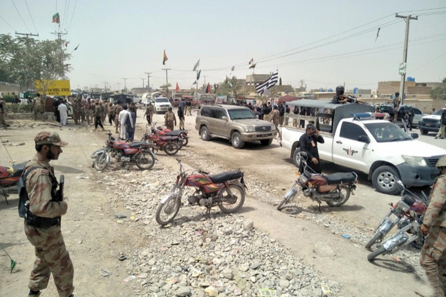 Security officers gather at the site of a blast outside a polling station in Quetta, Pakistan on Wednesday — Reuters