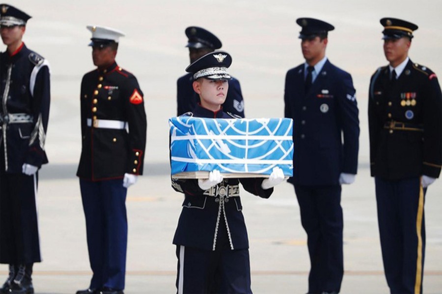 A soldier carrying a casket containing the remains of a US soldier killed during the 1950-53 Korean War, after arriving from North Korea at Osan Air Base in Pyeongtaek on Friday	— AFP