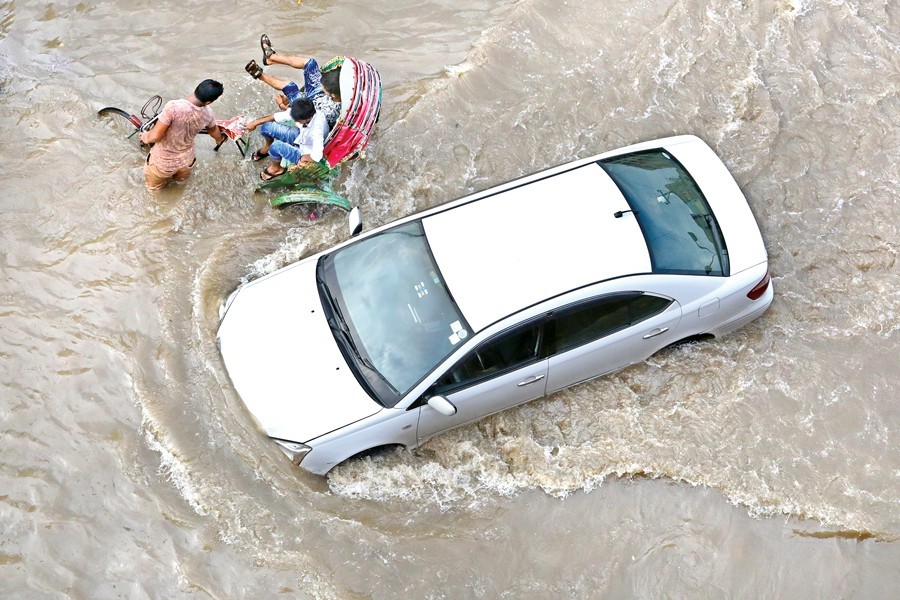 Vehicles plying the waterlogged main road at Kalshi in the capital's Mirpur area recently. The road regularly gets inundated during the rainy season — FE Photo