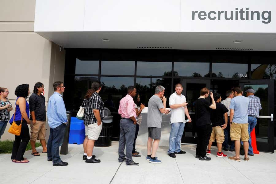 Job seekers line up to apply during "Amazon Jobs Day," a job fair being held at 10 fulfillment centers across the United States aimed at filling more than 50,000 jobs, at the Amazon.com Fulfillment Center in Fall River, Massachusetts, US, August 2, 2017. Reuters/File Photo