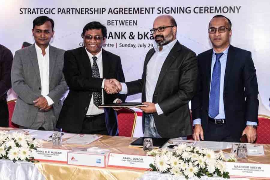 City Bank and bKash executives sign deal at City Bank HQ in Gulshan on Sunday. Photo: UNB