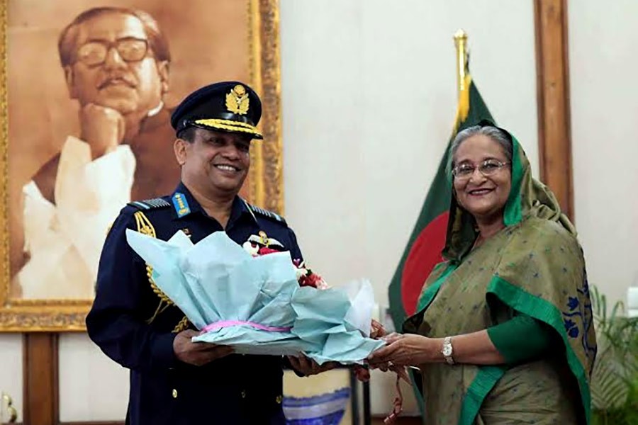 Prime Minister Sheikh Hasina congratulating Chief of Air Staff  Air Chief Marshal Masihuzzaman Serniabat by presenting a bouquet on Monday. -BSS Photo