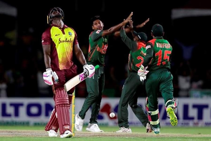 West Indies' Andre Russell, left, reacts after he was caught out off the bowling of Bangladesh's Mushfiqur Rahim, second from left, during a Twenty20 international cricket match Saturday, Aug 4, 2018, in Lauderhill, Fla - AP Photo