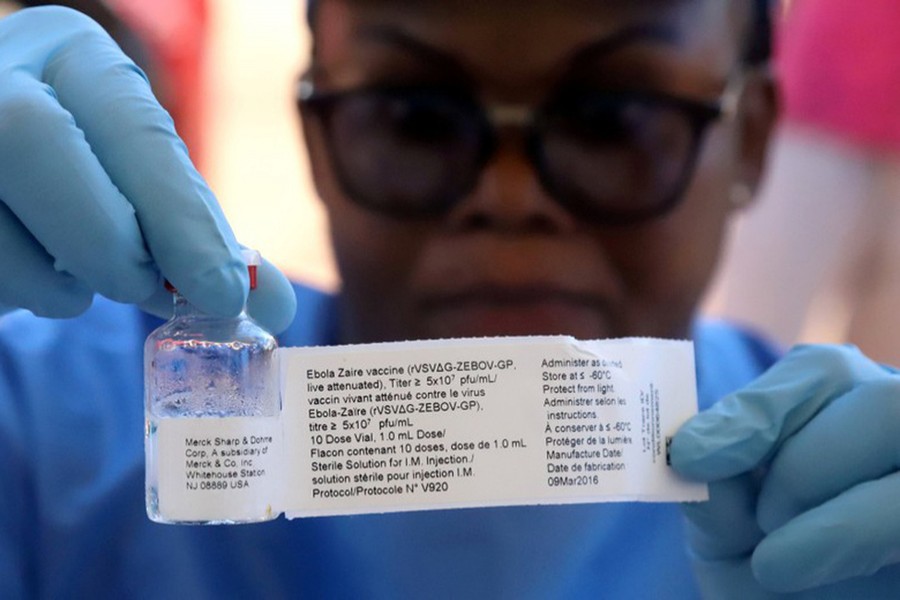 A World Health Organization (WHO) worker prepares to administer a vaccination during the launch of a campaign aimed at beating Ebola. File photo