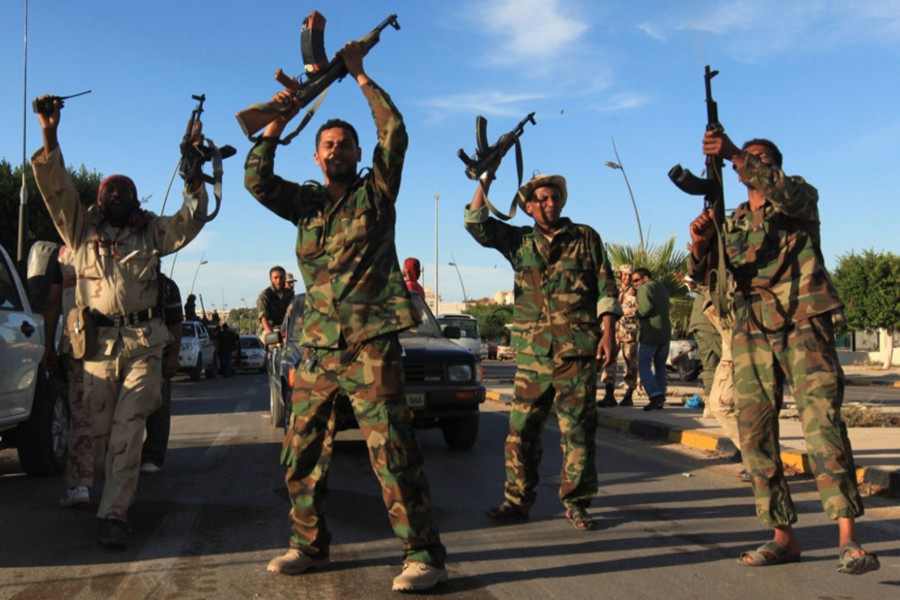 Anti-Gaddafi fighters fire their rifles as they celebrate the fall of Sirte in 2011 — Reuters/File