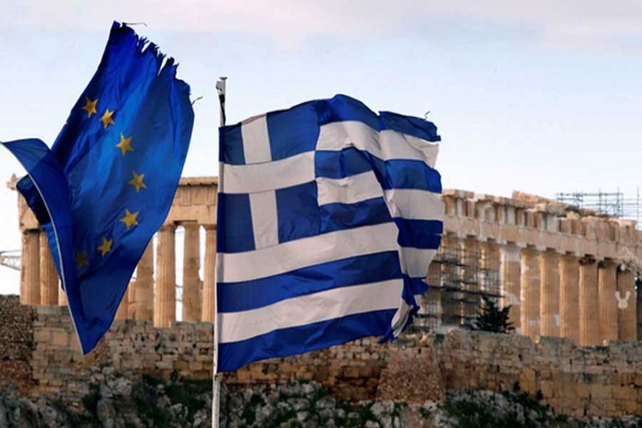 The Parthenon on the Athens Acropolis is seen behind a Greek and an EU flag atop the Greek ministry of finance Feb 8, 2012. Greek parties will try again on Wednesday to agree a reform deal in return for a new international rescue to avoid a chaotic default, after delays prompted some EU leaders to warn that the euro zone can live without Athens. Reuters/Files