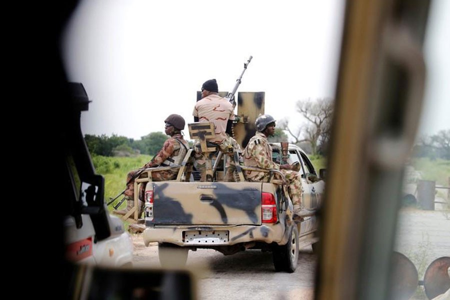 A Nigerian army convoy vehicle drives ahead with an anti-aircraft gun, on its way to Bama, Borno State, Nigeria August 31, 2016 – Reuters