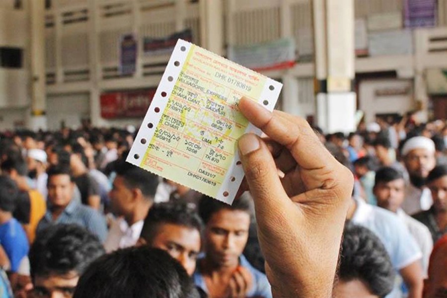 A passenger holds his train ticket after managing to purchase one before Eid holidays. File photo