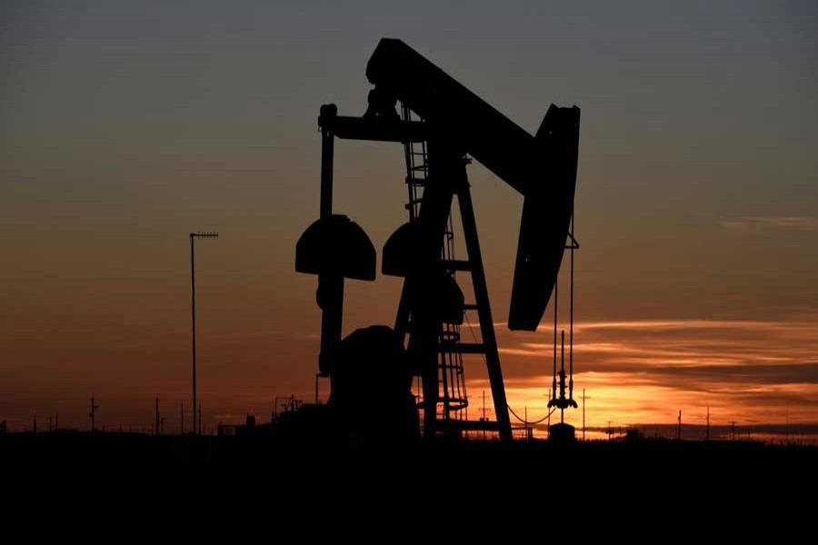 A pump jack operates at sunset in an oil field in Midland, Texas, US, August 22, 2018. Reuters