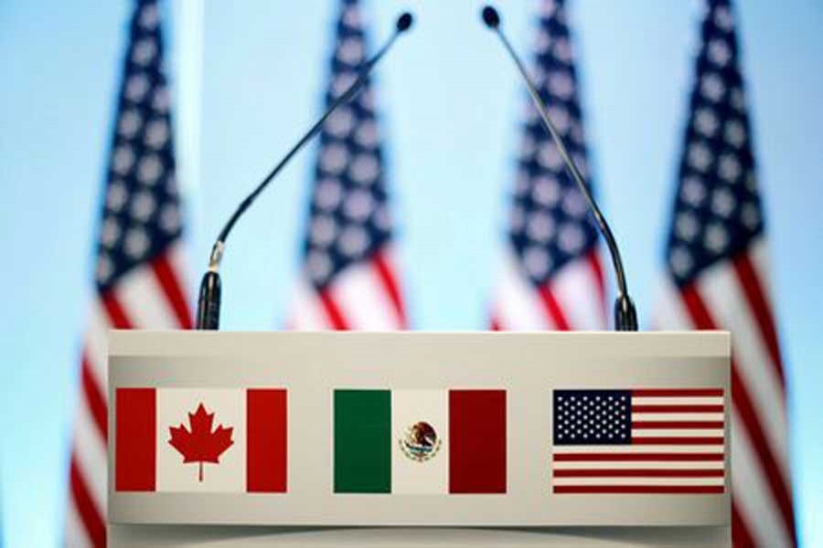 The flags of Canada, Mexico and the US are seen on a lectern before a joint news conference on the closing of the seventh round of NAFTA talks in Mexico City, Mexico, March 5, 2018. Reuters/File Photo