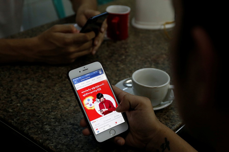 A cellphone user looks at a Facebook page at a shop in Latha street, Yangon, Myanmar on August 8, last — Reuters/File