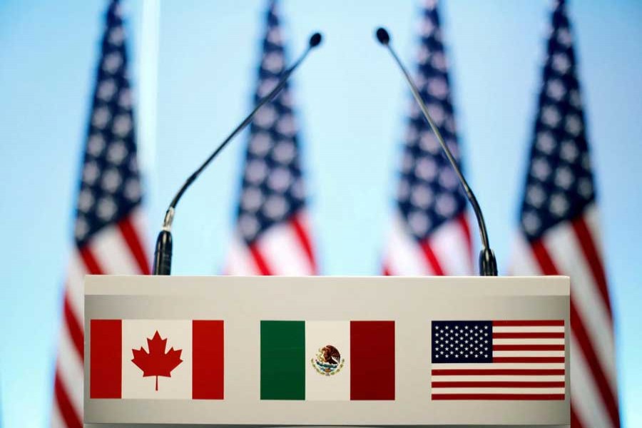 The flags of Canada, Mexico and the US are seen on a lectern before a joint news conference on the closing of the seventh round of NAFTA talks in Mexico City, Mexico, March 5, 2018. Reuters/File Photo