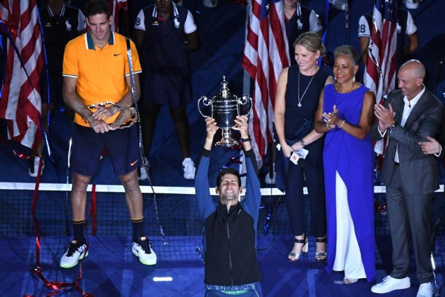 Novak Djokovic of Serbia poses with the championship trophy after defeating Juan Martin Del Potro of Argentina in the men's final of the 2018 US Open tennis tournament — USA TODAY Sports photo via Reuters