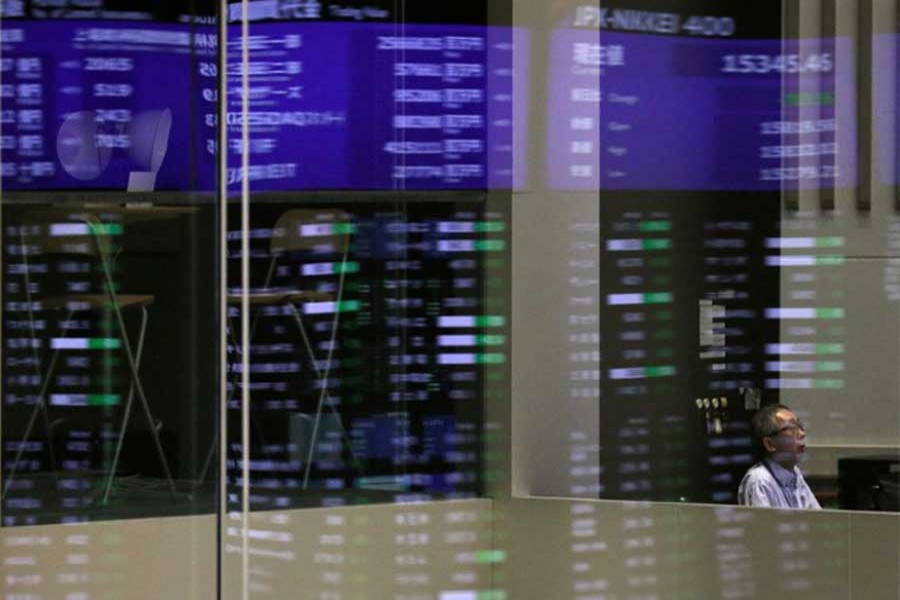 Market prices are reflected in a glass window at the Tokyo Stock Exchange (TSE) in Tokyo, Japan, February 6, 2018. Reuters/Files