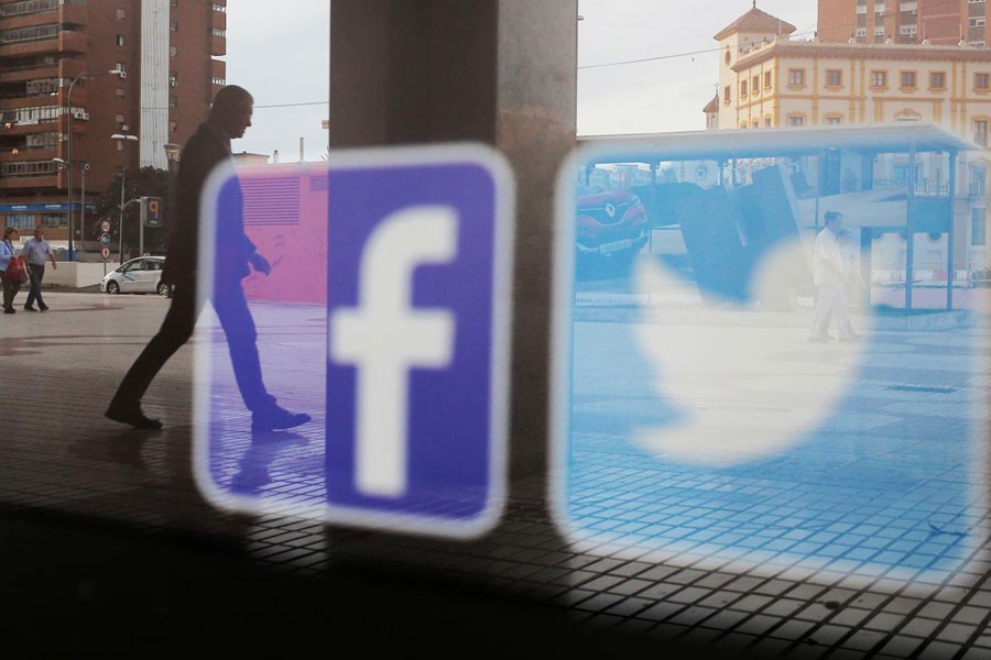 Facebook and Twitter logos are seen on a shop window in Malaga, Spain, June 4, 2018 - Reuters File Photo