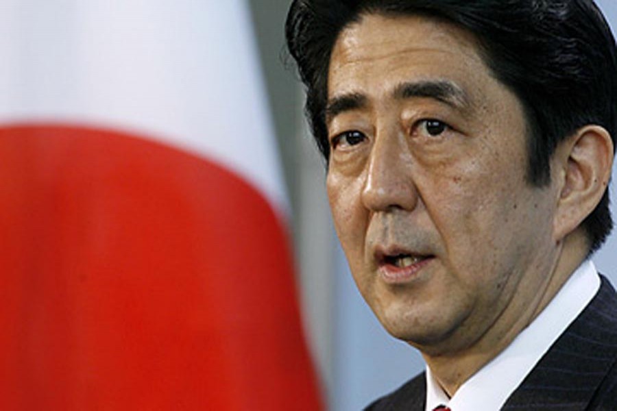 Japan's Abe re-elected as party head, to stay on as PM