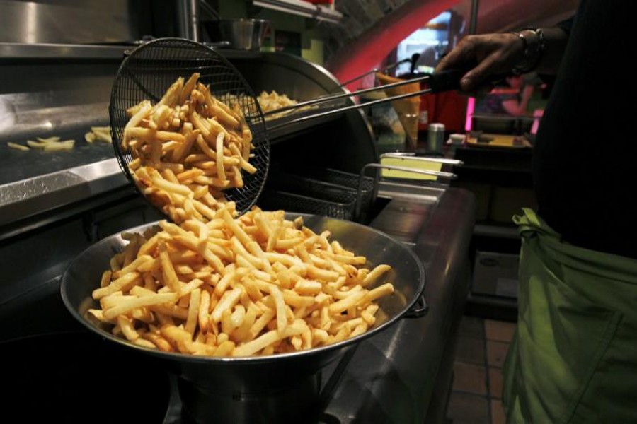 A cook prepares fries in a cafe at the Frietmuseum in Bruges, Belgium. Reuters photo