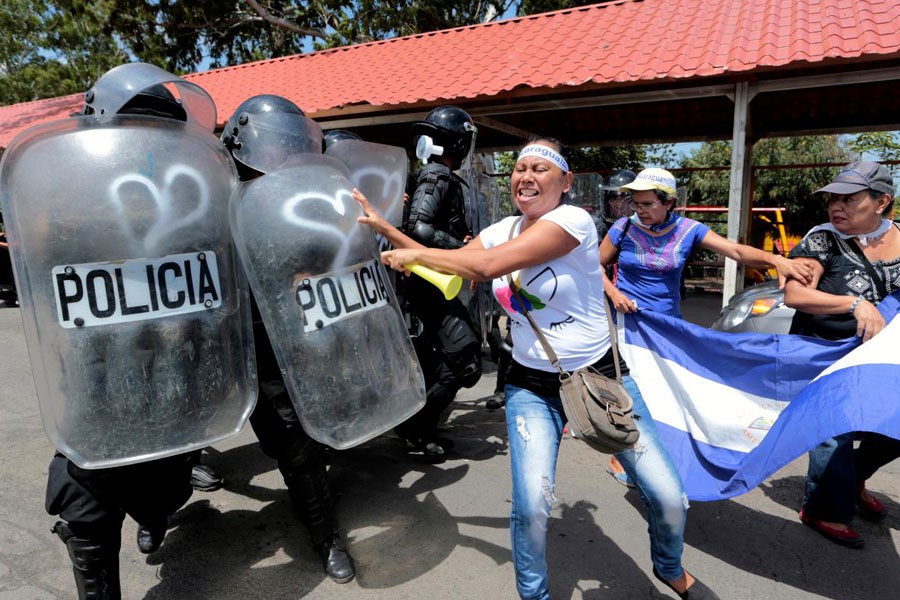 A demonstrator clashes with riot police during a protest against Nicaraguan President Daniel Ortega's government in Managua, Nicaragua September 23, 2018 – Reuters