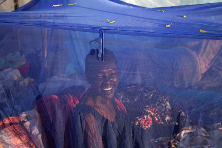 A woman sits inside a mosquito tent in the town of Abyei, Sudan. Reuters/File photo