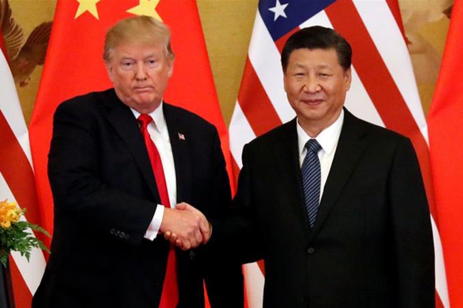 A file photo showing US President Donald Trump shaking hands with China’s President Xi Jinping during a meeting recently	— Reuters