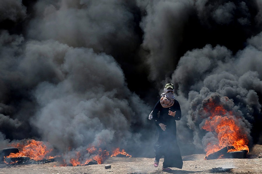 A female Palestinian demonstrator gestures during a protest against US embassy move to Jerusalem and ahead of the 70th anniversary of Nakba, at the Israel-Gaza border, east of Gaza City- Reuters Photo