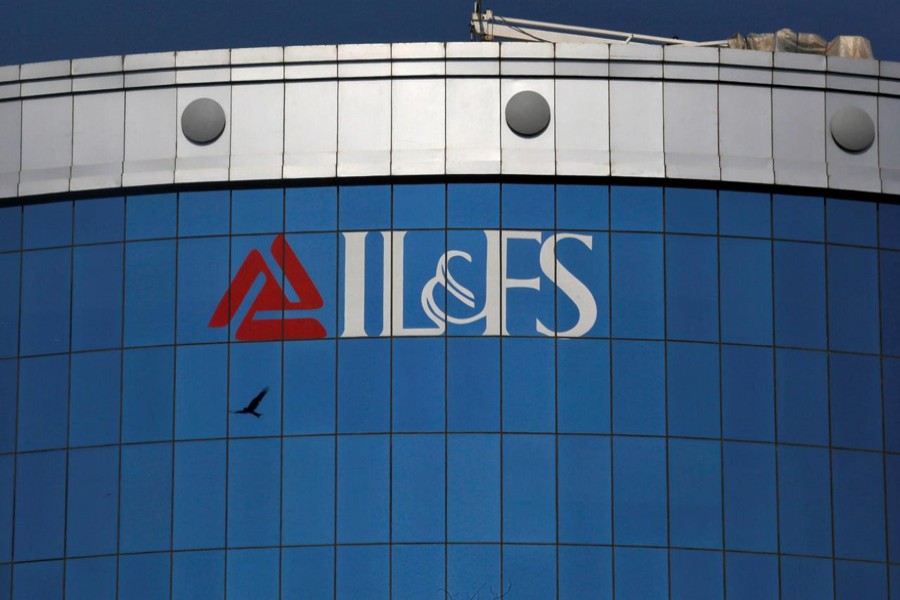 A bird flies next to the logo of IL&FS (Infrastructure Leasing and Financial Services Ltd.) installed on the facade of a building at its headquarters in Mumbai, India, September 25, 2018. Reuters