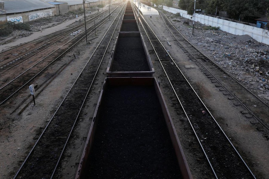 A cargo train loaded with coal dust, moves past the port area near City Station in Karachi, Pakistan, September 24, 2018. Reuters