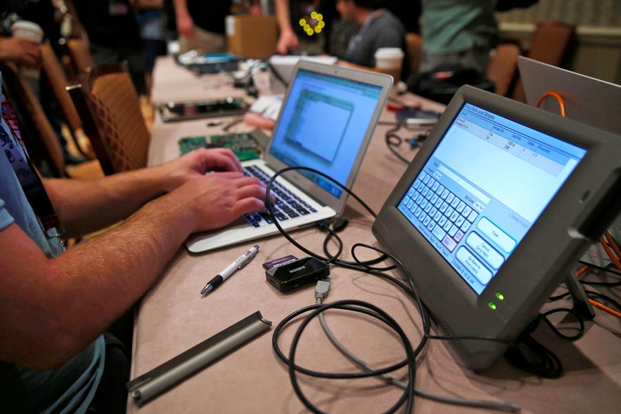 A hacker tries to access and alter data from an electronic poll book at Defcon's Voting Village in Las Vegas, Nevada on July 29, 2017. Photo: Collected