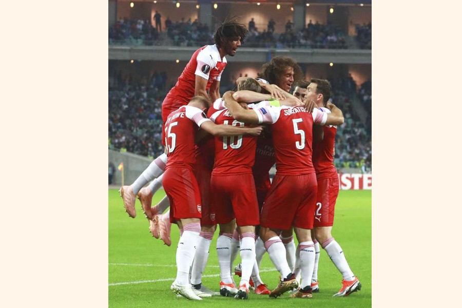 Arsenal's players celebrating after scoring the opening goal during a Group E Europa League match against Qarabag FK at the Olympic stadium at Baku in Azerbaijan on Thursday	— AP