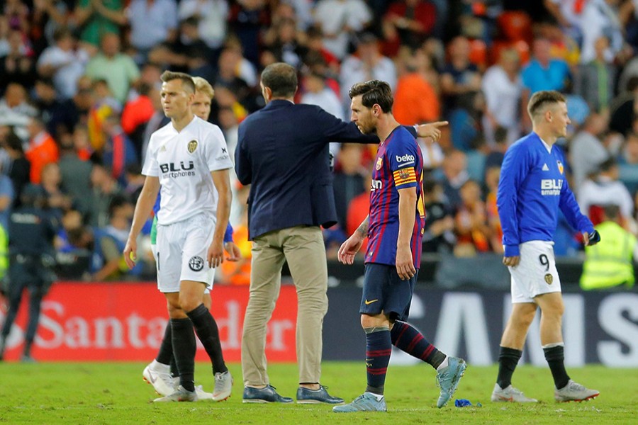 Lionel Messi cuts a dejected figure after the 1-1 draw against Valencia — Reuters photo