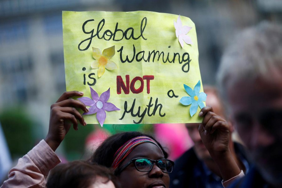 People take part in protests ahead of the upcoming G20 summit in Hamburg, Germany, July 2, 2017. Placard reads "Global Warming is NOT a Myth". Reuters/File Photo