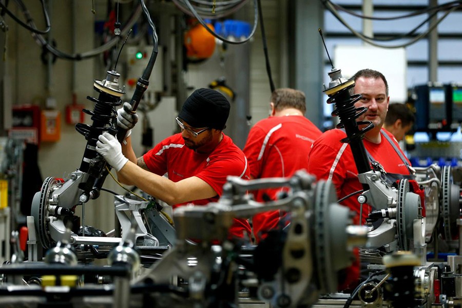 Employees of German car manufacturer Porsche work chassis at the Porsche factory in Stuttgart-Zuffenhausen, Germany on January 26, 2018 — Reuters/File