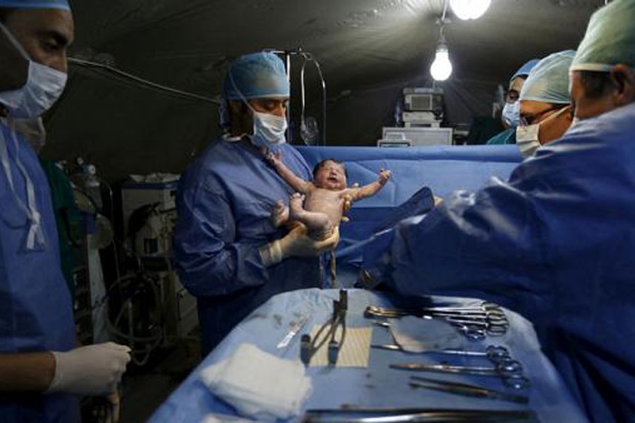 Moroccan doctors carry a Syrian baby Siwar, who was born by caesarean section in a field hospital in Al Zaatari refugee camp in the Jordanian city of Mafraq, near the border with Syria, March 7, 2016. Reuters/File photo