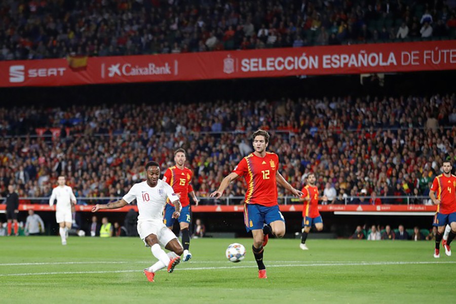 England's Raheem Sterling scores their first goal — Reuters action image