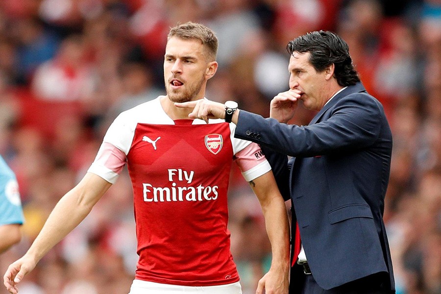 Arsenal manager Unai Emery speaks with midfielder Aaron Ramsey before his substitution — Reuters file photo