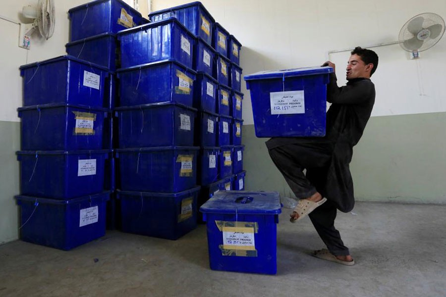 An Afghan election commission worker prepares ballot boxes and election material to send to the polling stations at a warehouse in Jalalabad city, Afghanistan October 19, 2018 – Reuters