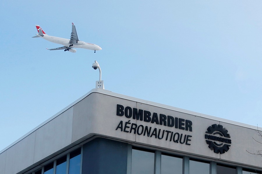 A plane flies over a Bombardier plant in Montreal, Quebec, Canada on January 21, 2014 — Reuters/File