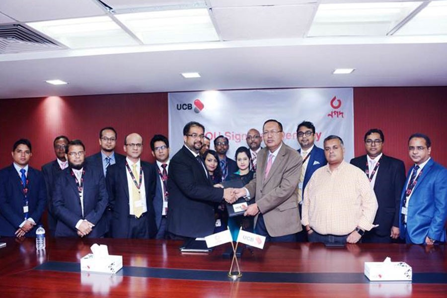 Md Sohrab Mustafa, Deputy Managing Director, UCB and Mostafa Kamal Ahmed FCA, Head of Finance & Company Secretary, NAGAD signing the MOU along with Md Abdullah Al Mamoon, DMD, UCB and other senior officials from both the organisations