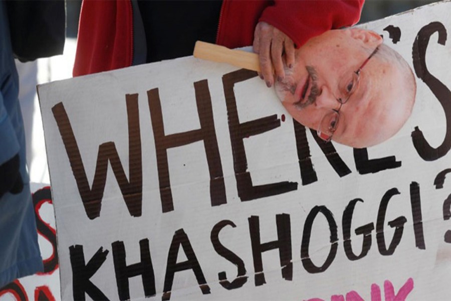 An activist holds a sign and image of missing Saudi journalist Jamal Khashoggi during a demonstration calling for sanctions against Saudi Arabia and to protest Khashoggi's disappearance, outside the White House in Washington, US, October 19, 2018. Reuters/File Photo