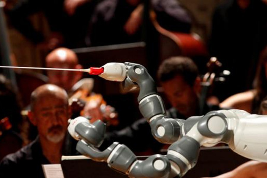 Humanoid robot YuMi conducts the Lucca Philharmonic Orchestra performing a concert alongside Italian tenor Andrea Bocelli (unseen) at the Verdi Theatre in Pisa, Italy September 12, 2017. Reuters/File photo